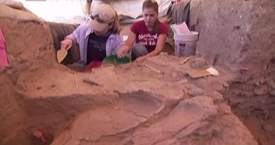 Student volunteers help with the excavation